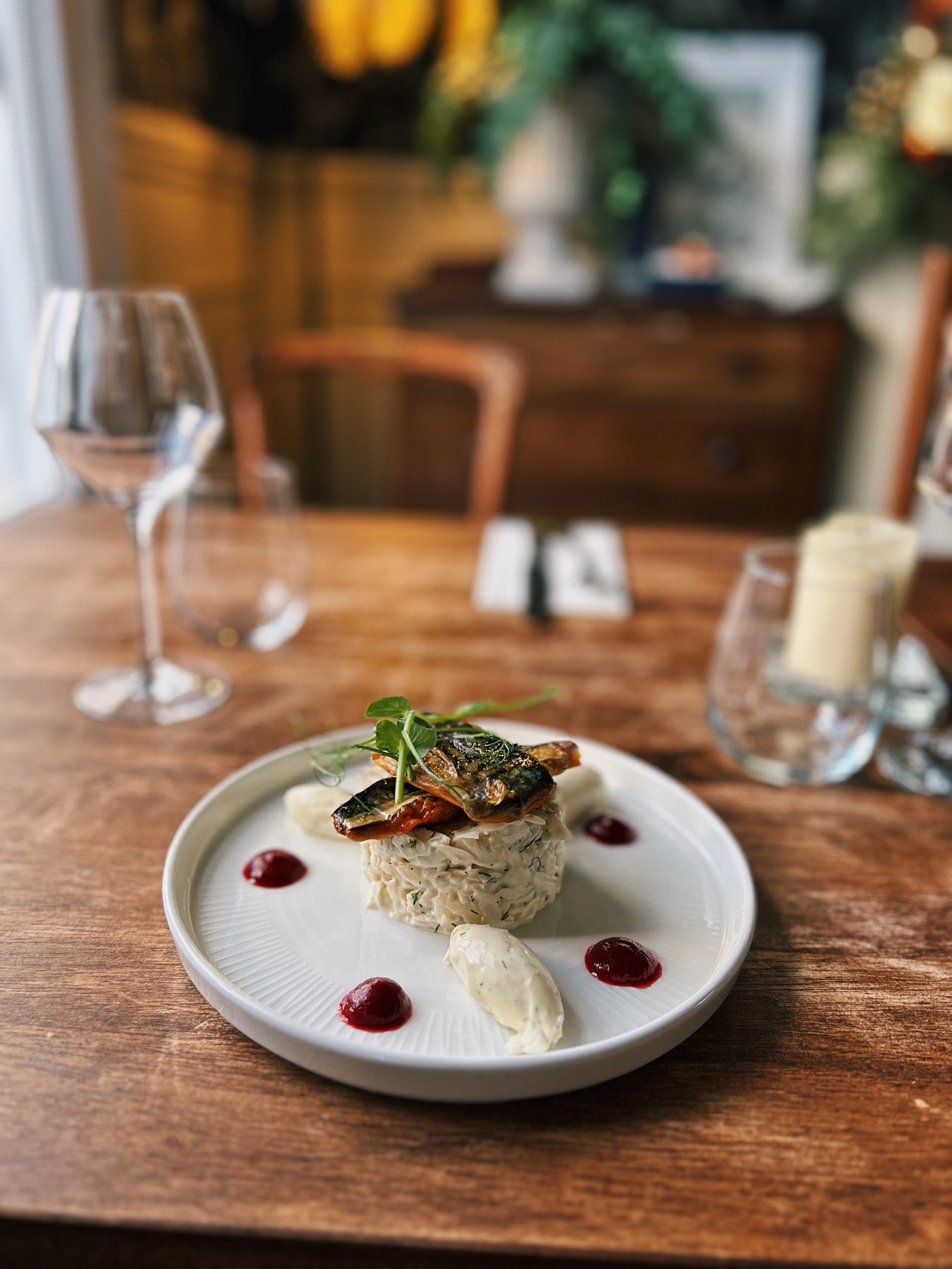A plated fish dish with beurre blanc at The Priory